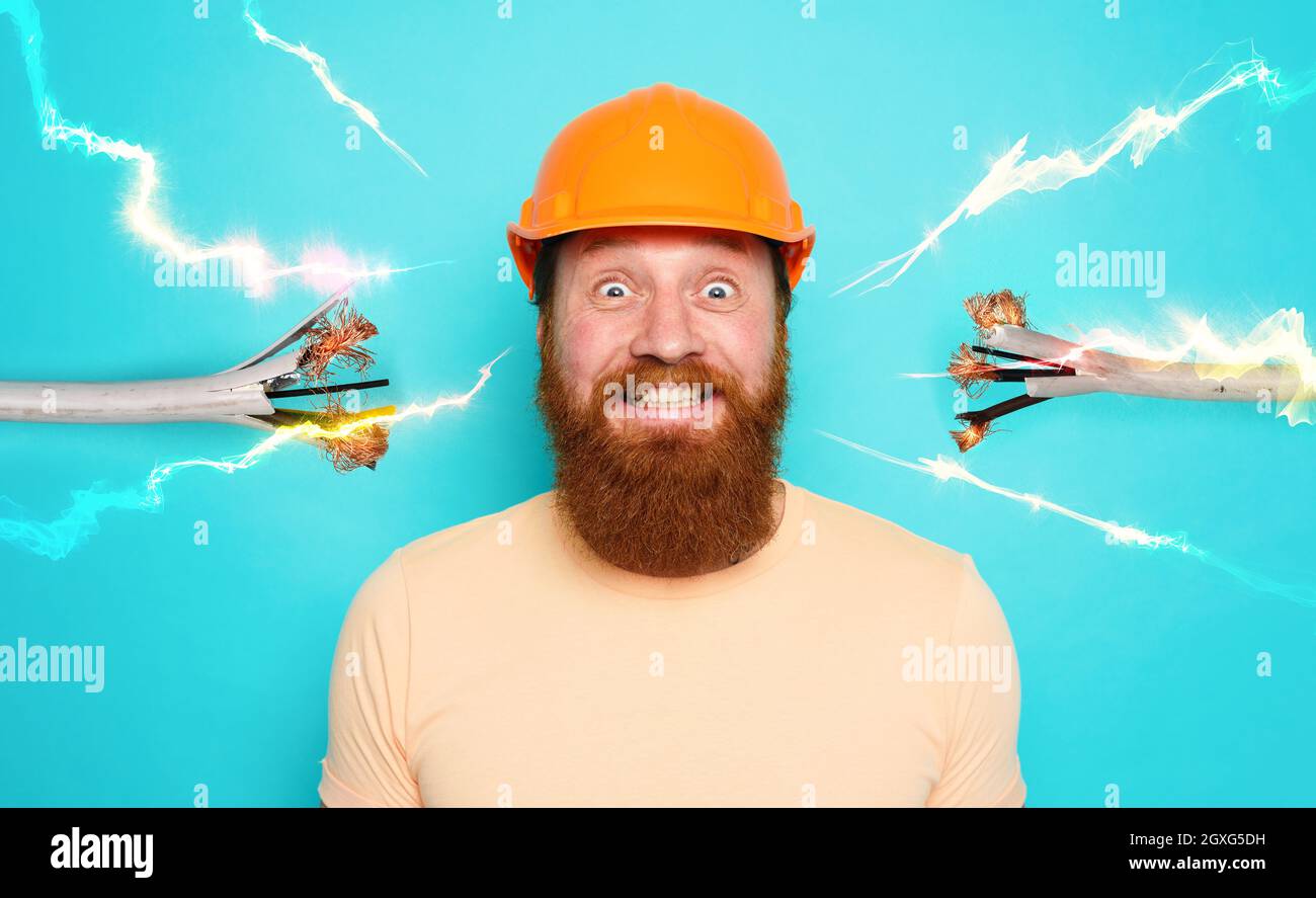 Incompetent worker electrician is unsure about his work Stock Photo