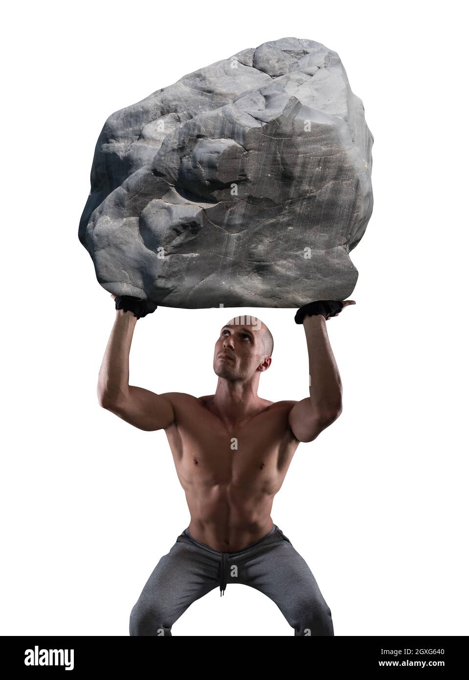 Muscular man with determination lifts a big boulder Stock Photo