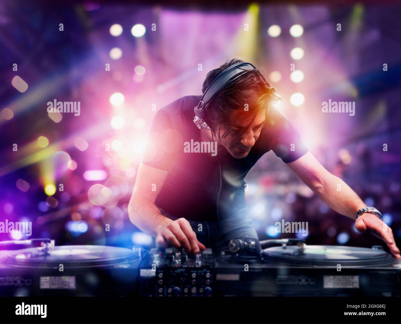 DJ at work playing music with a mixer at the discotheque Stock Photo ...