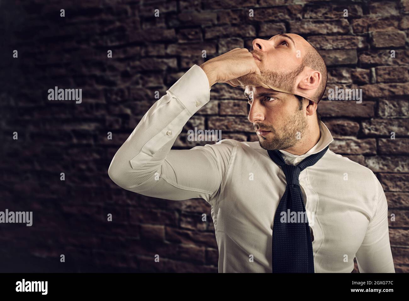 Businessman with multiple personality changes the mask. Concept of falsity Stock Photo