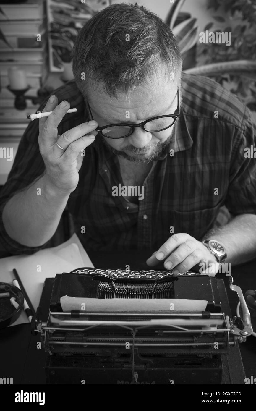 a beautiful old retro typewriter. man typing novel on retro typewriter Stock Photo