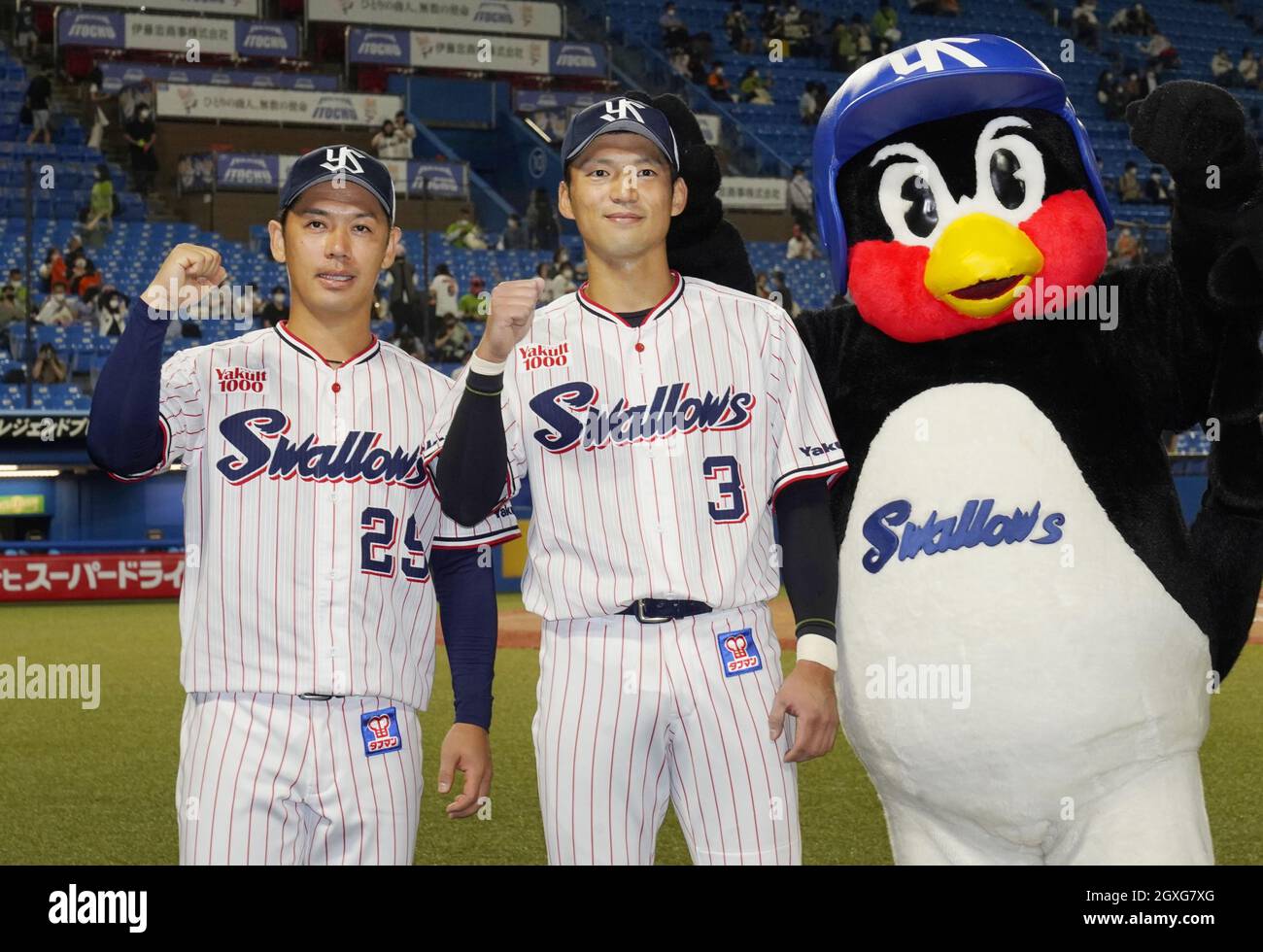 Yakult Swallows pitcher Yasuhiro Ogawa (29) and shortstop Naomichi Nishiura  (3) pose for photos after leading the team to a 3-2 win over the Yomiuri  Giants at Jingu Stadium in Tokyo on
