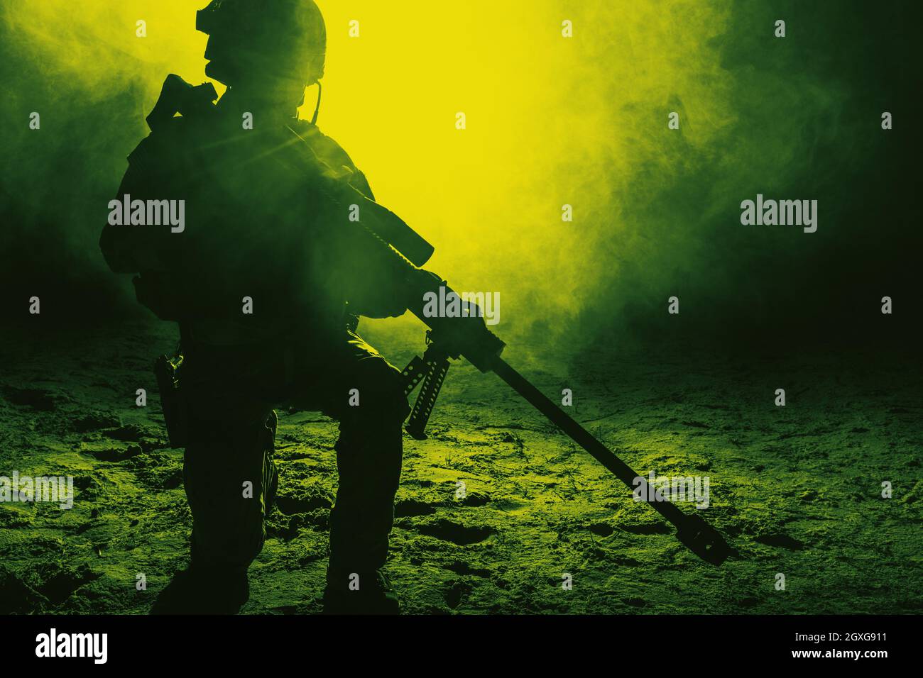 Army sniper with large caliber rifle sitting in the fire and smoke. Backlit silhouette, toned image Stock Photo