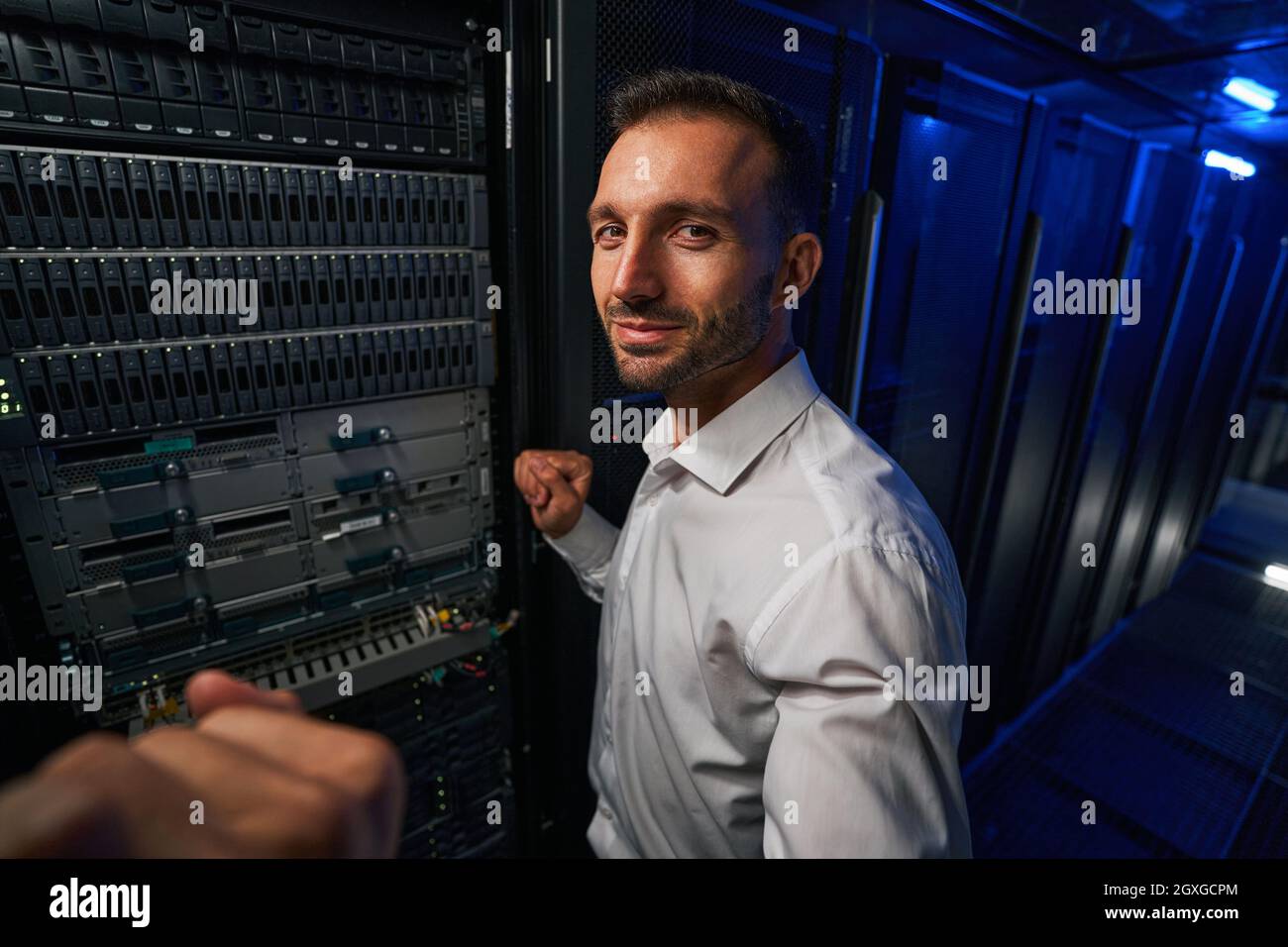 Bearded man technician working with it equipments in server farm Stock Photo