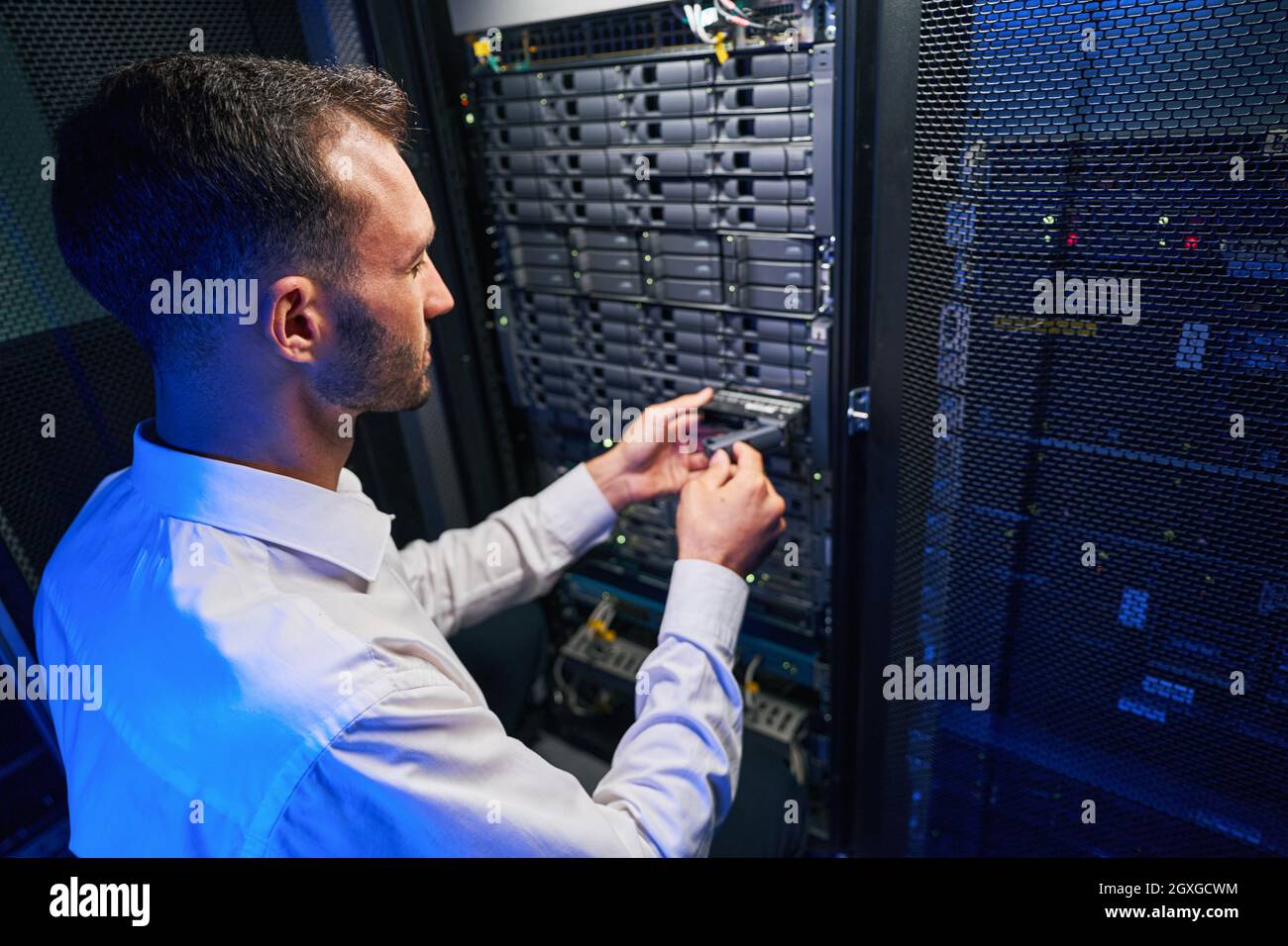 Busy maintenance administrator disassembling and repairing computer
