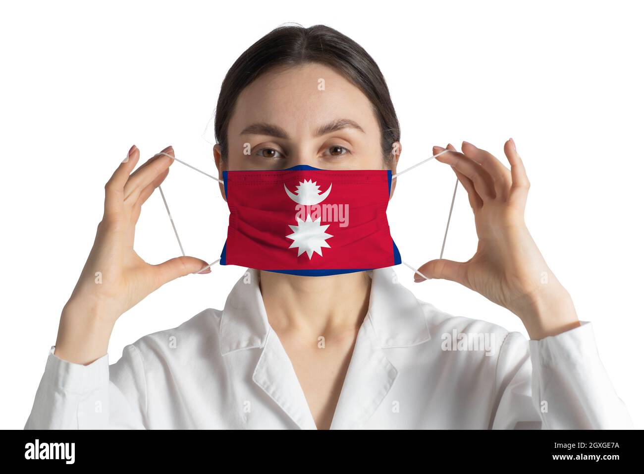 Respirator with flag of Nepal Doctor puts on medical face mask isolated on white background. Stock Photo