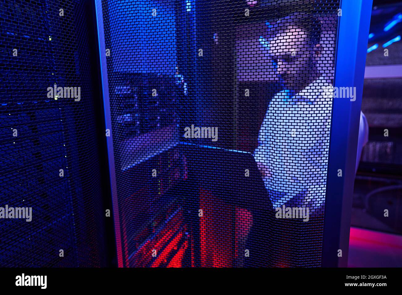 Bearded Caucasian programmer finding and troubleshooting computer server in data center Stock Photo