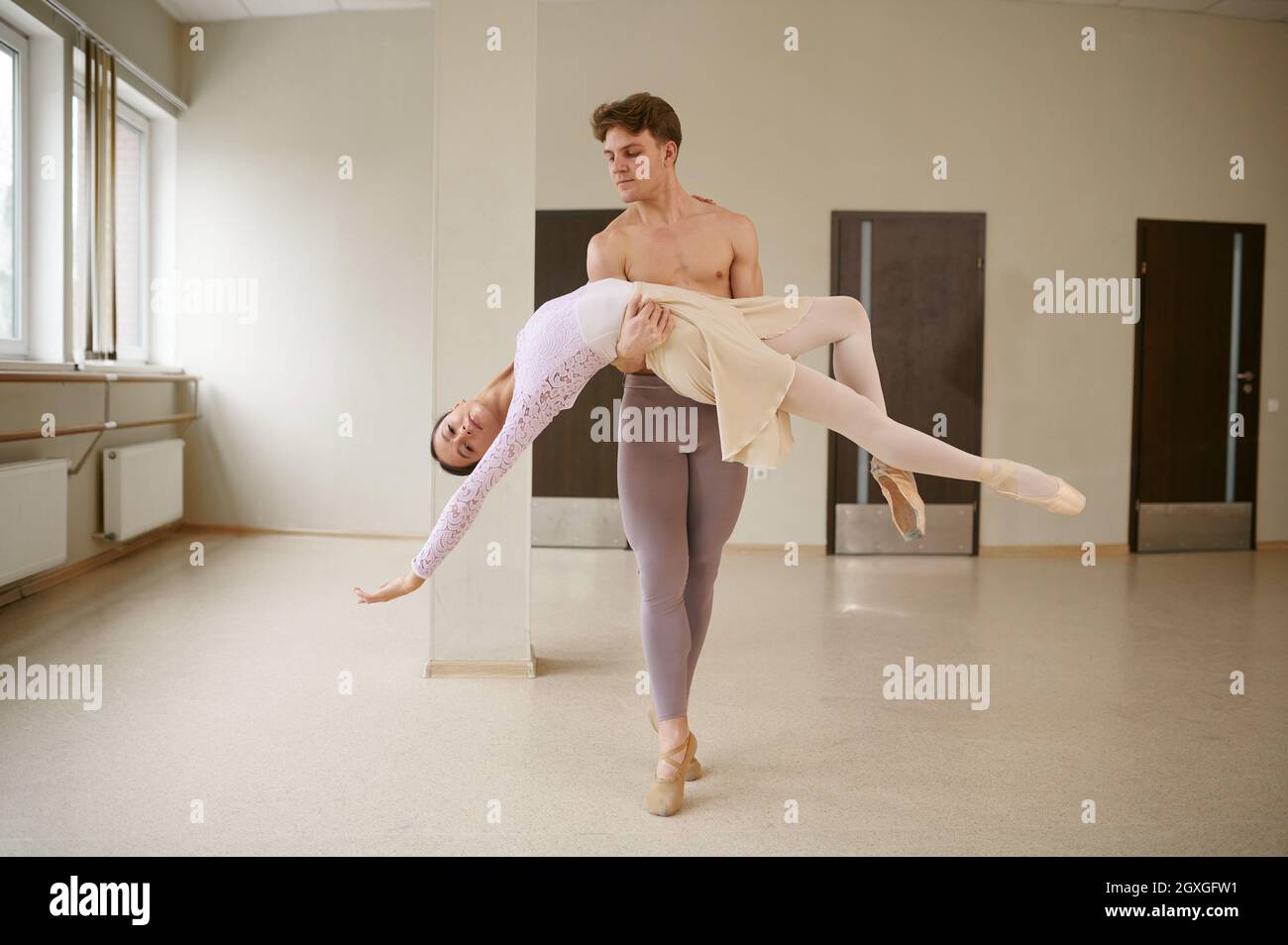 Couple of ballet dancers, dancing in action. Ballerina with partner ...