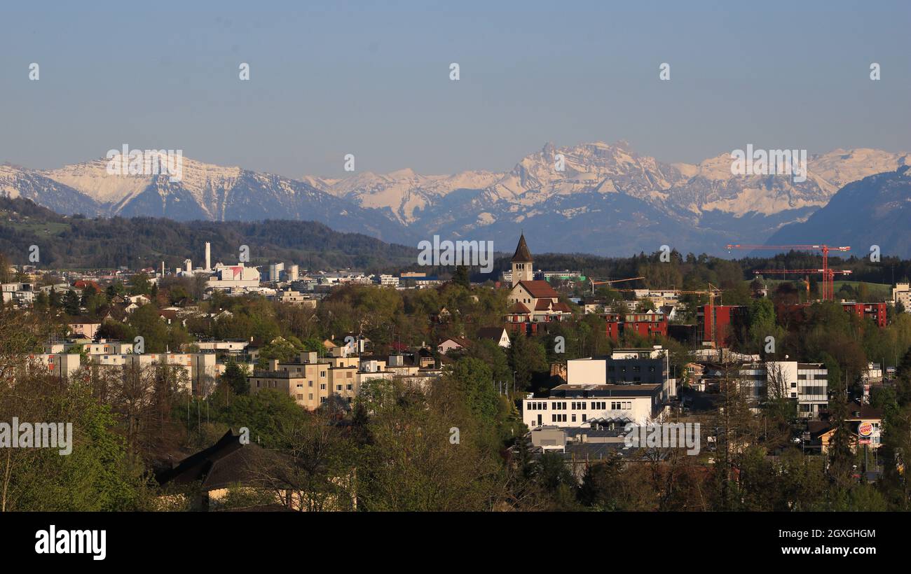 Houses in Wetzikon and snow covered mountains. Stock Photo