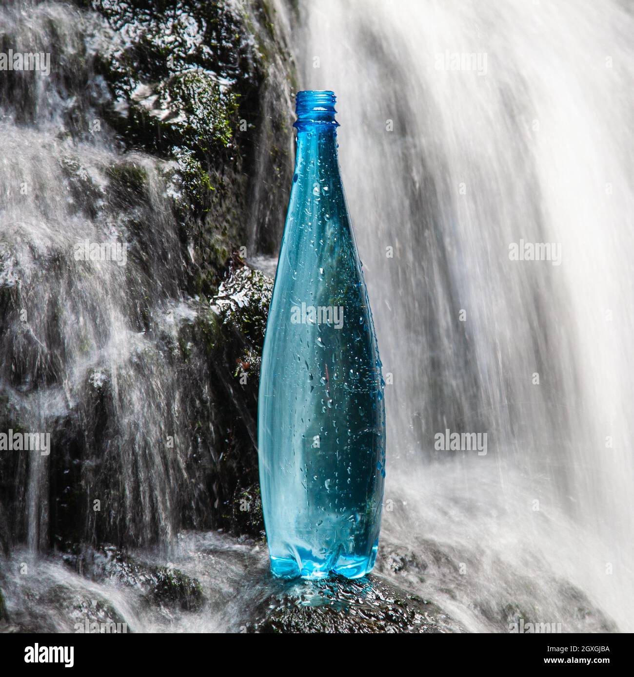 Blue bottle of mineral water in the nature Stock Photo Alamy