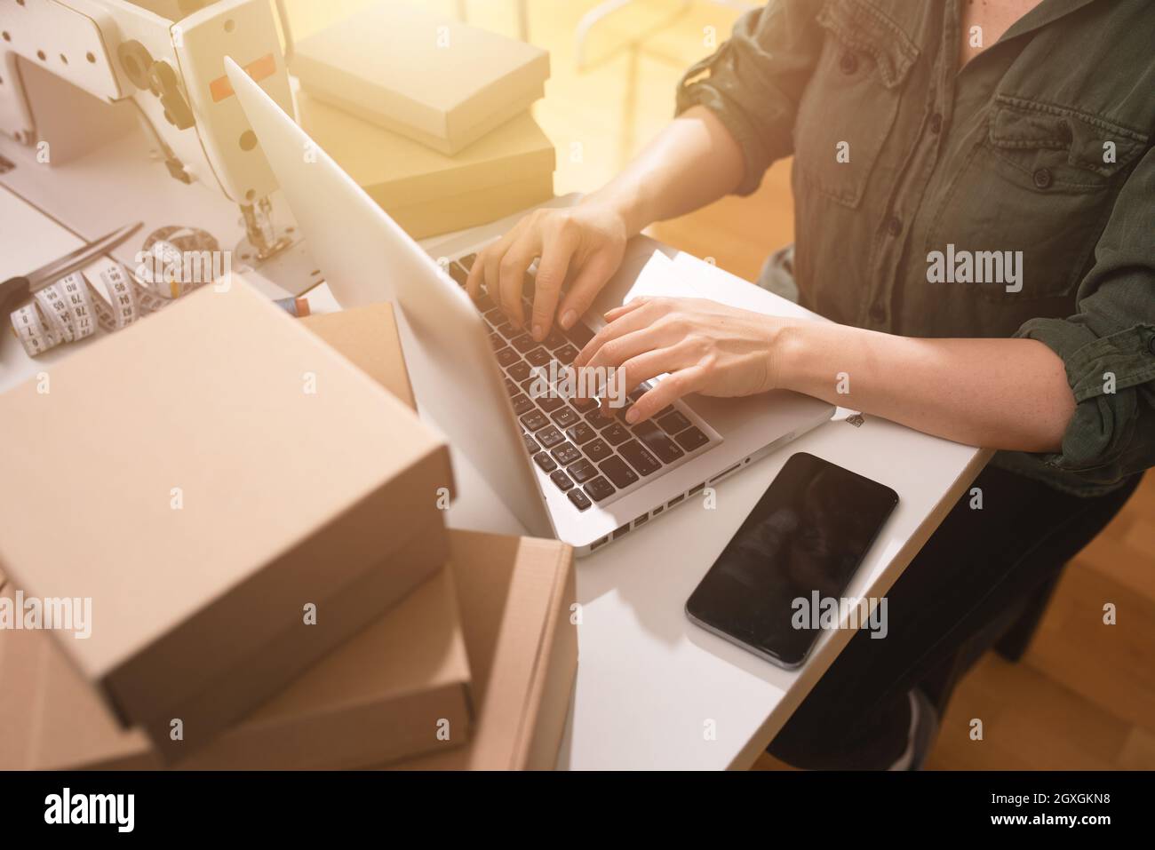 Seamstress works to new clothes ordered by online order Stock Photo