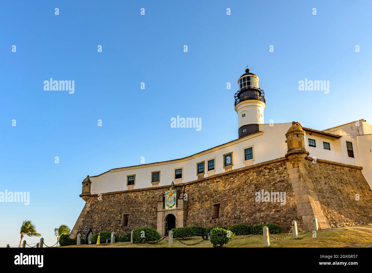Facade of the old and historic fort and Barra lighthouse (Farol da Barra) at afternoon in the city of Salvador, Bahia Stock Photo