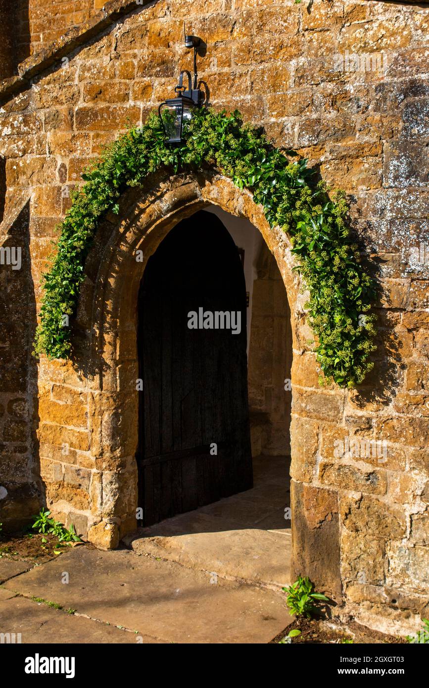 UK, England, Oxfordshire, Banbury, Hornton, Church of St John the Baptist, Autumn wedding ivy decorating porch Stock Photo