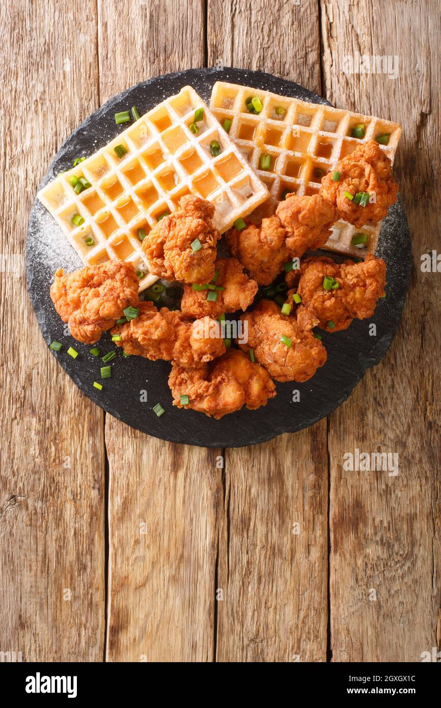 Fried Breaded Chicken pieces and Belgian waffles with creamy honey