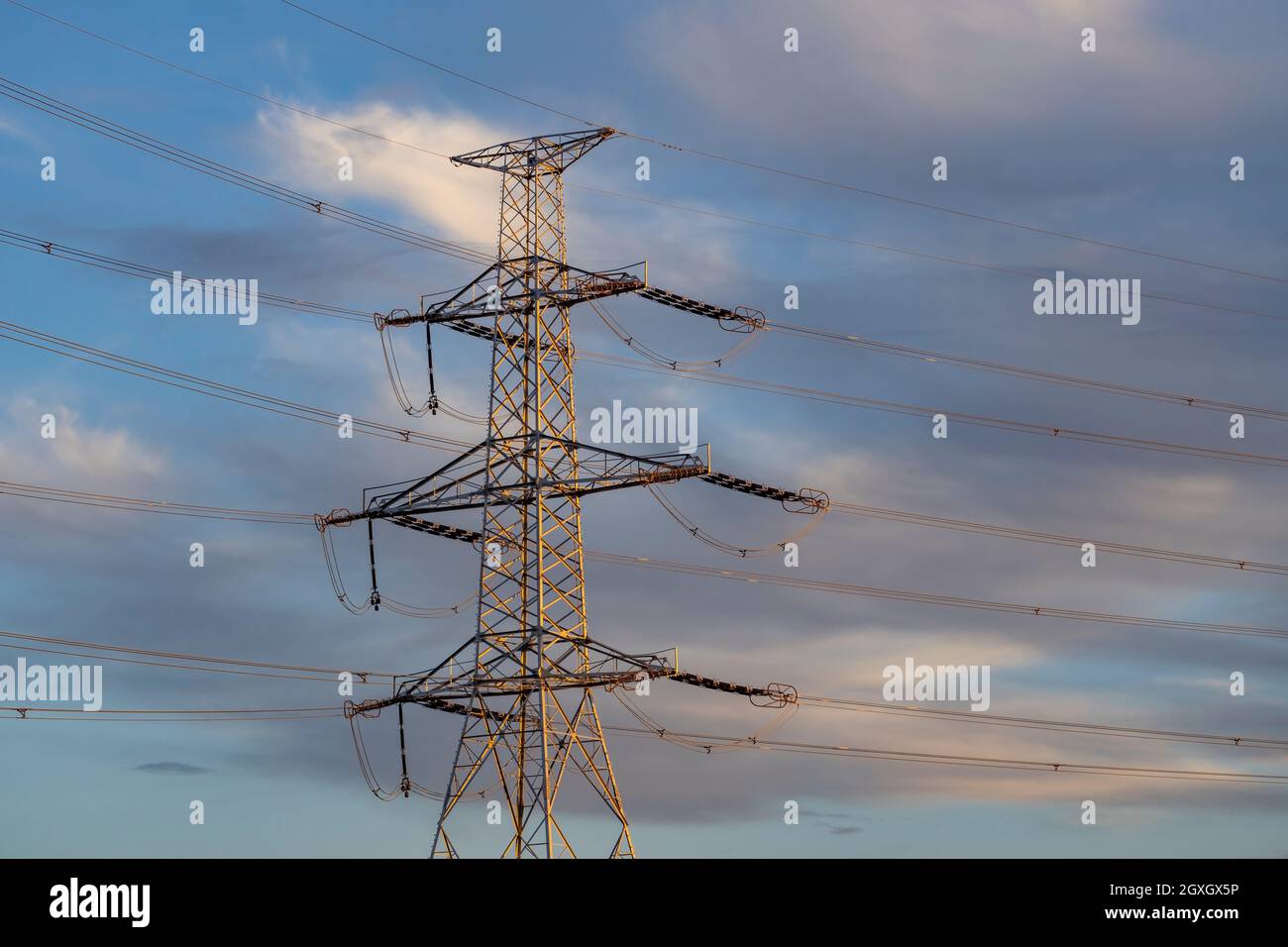high voltage electric pylon with blue sky Stock Photo - Alamy