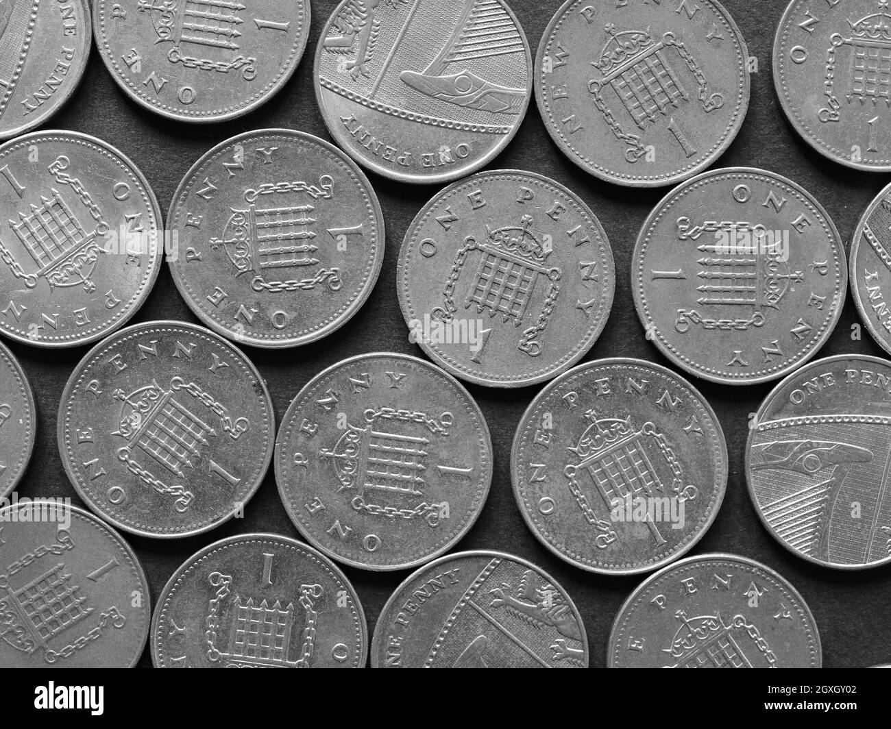 Pound coins money (GBP), currency of United Kingdom, over black background in black and white Stock Photo