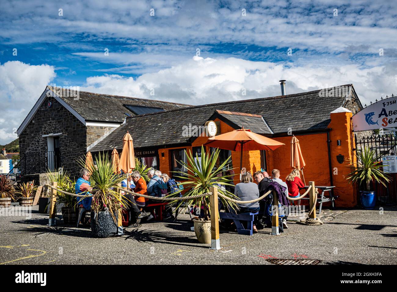 Cafe society,outside cafe enjoying  the good weather in Aberaeron Wales UK Al fresco Stock Photo