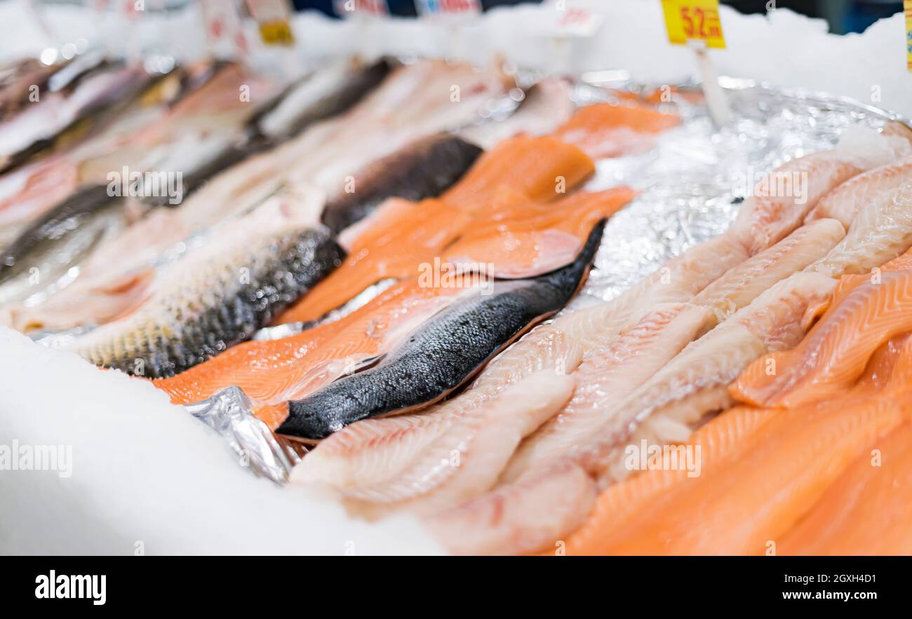 Fresh fish fillet put up for sale in a supermarket refrigerator Stock