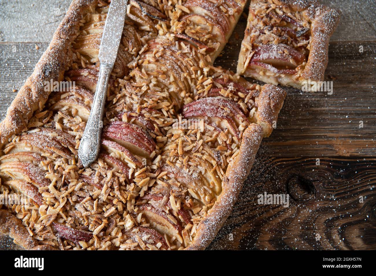 Rustic apple pie or cake with almonds baked with yeast dough and fresh fruits from the garden Stock Photo