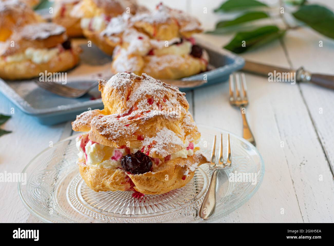 Homemade Cream puff pastry with whipped cream and cherries Stock Photo