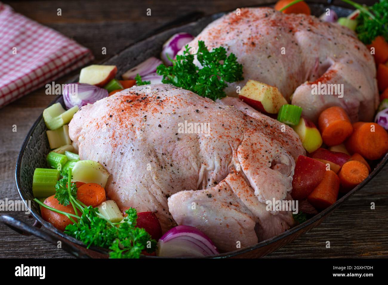 Roast chicken preparation with raw and uncooked whole chicken with root
