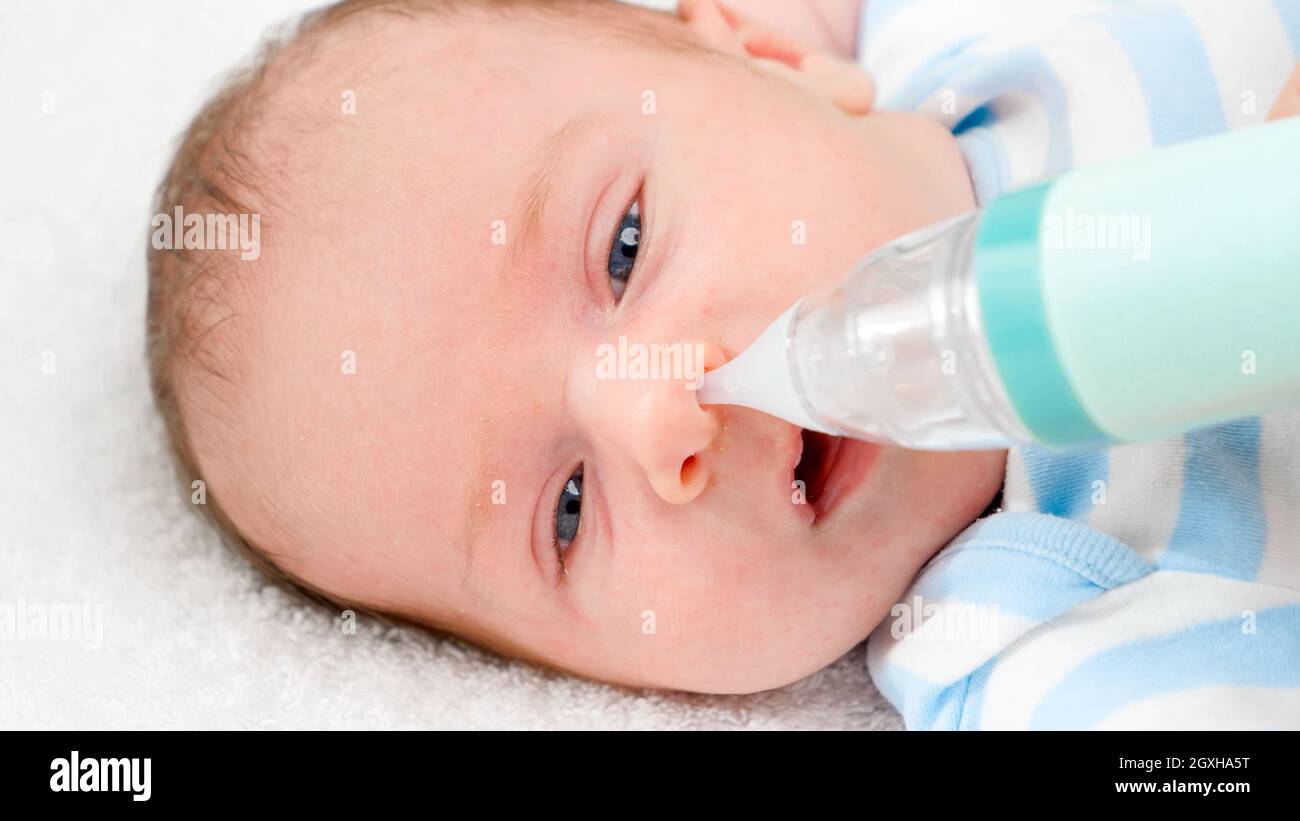 Closeup slow motion of cleaning tiny nose of newborn baby with electric  aspirator. Concept of babies and newborn hygiene and healthcare. Caring  parent Stock Photo - Alamy