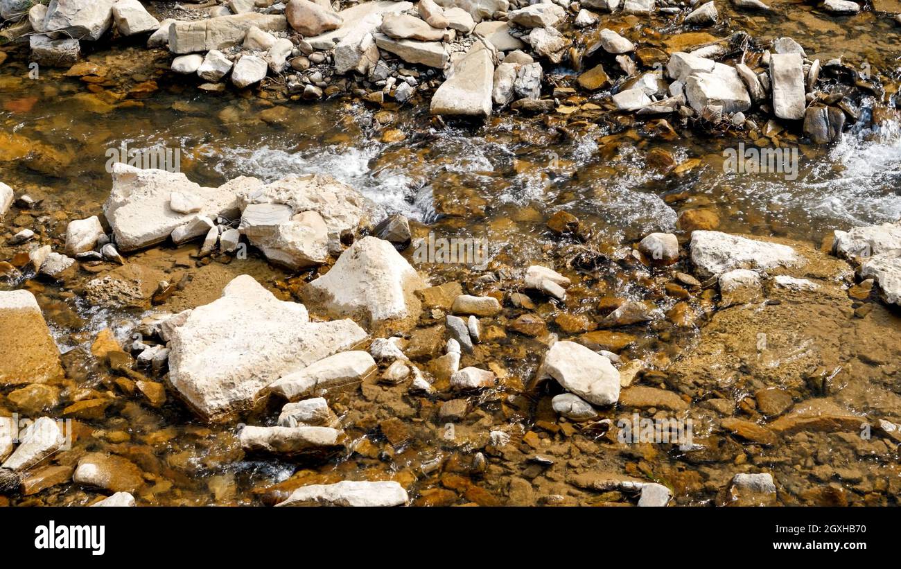 Top view of sharp rocks and stones in fast mountain river at sunny ...