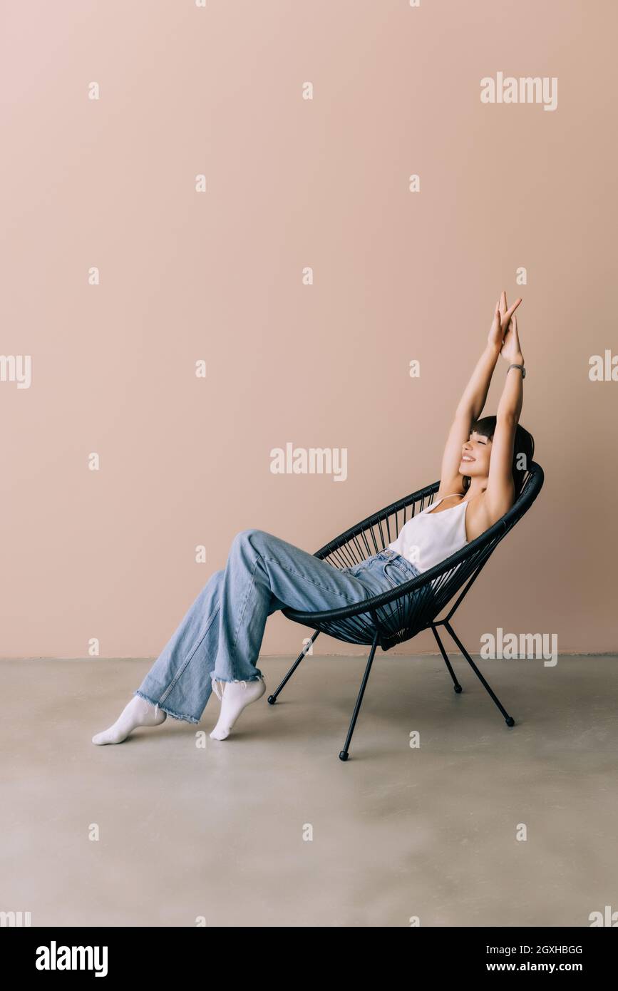 Resting In Chair Young woman resting in lounge chair at home Stock Photo - Alamy