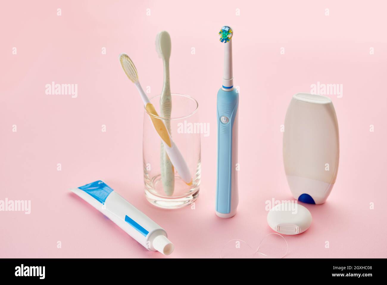 Oral care products, toothbrush, toothpaste and dental floss, pink  background, nobody. Morning healthcare procedures concept Stock Photo -  Alamy