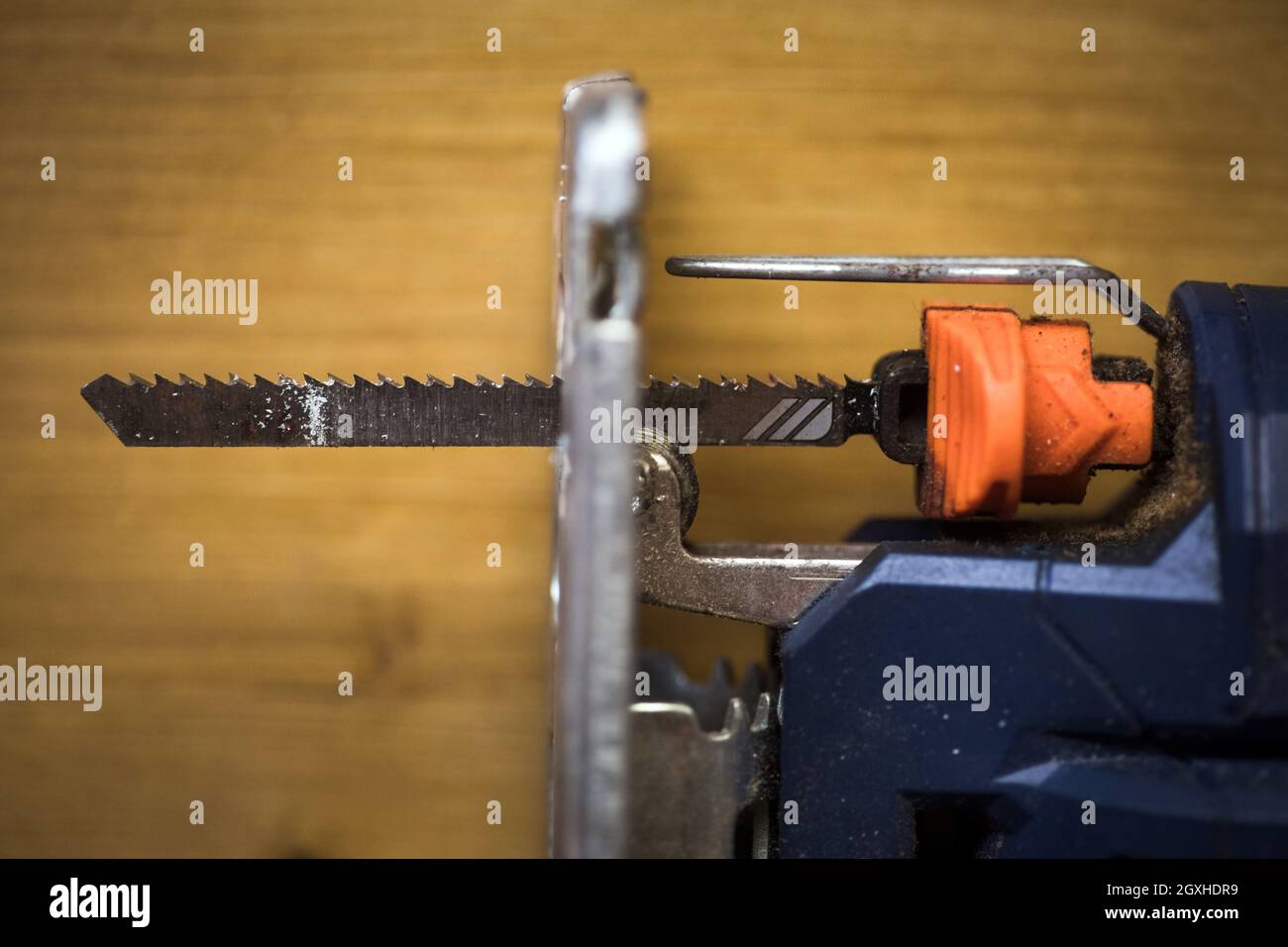 Detail of an electric jig saw on a wooden background. Stock Photo