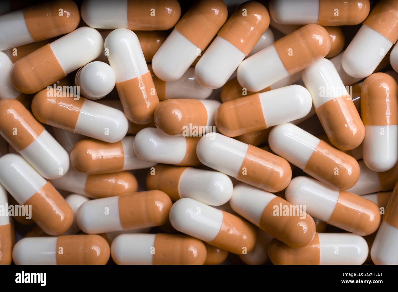 Orange and white capsule pills background, top view Stock Photo Alamy