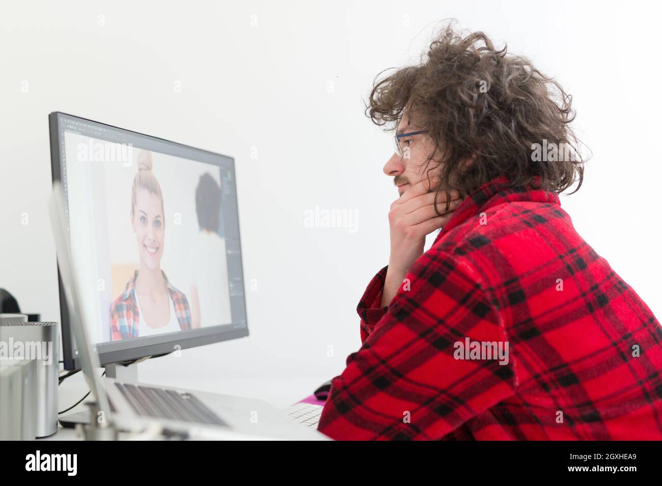 young graphic designer in bathrobe working at home office using computer Stock Photo