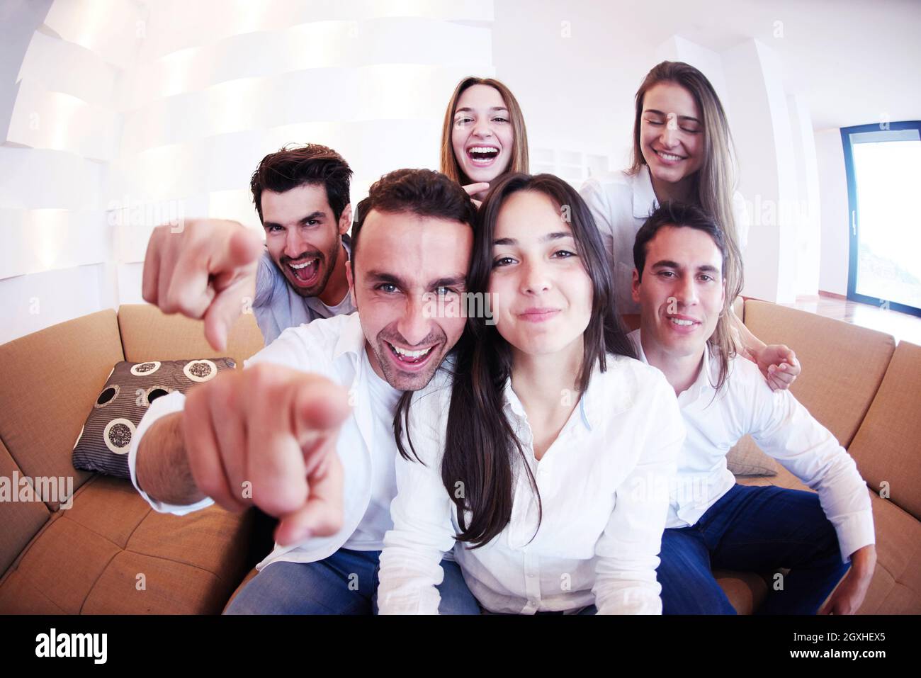 group of friends taking selfie photo with tablet at modern home indoors ...