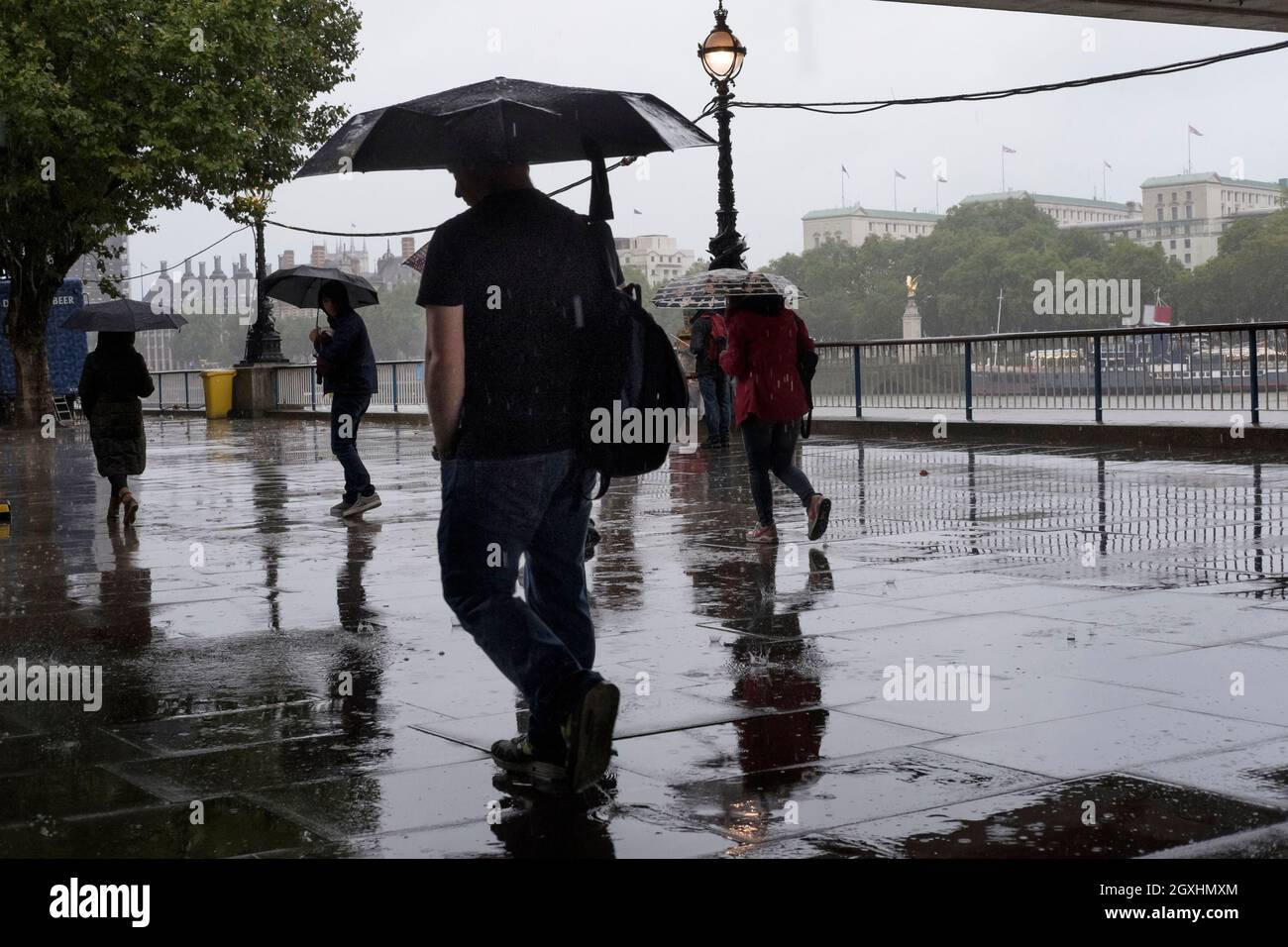 London pedestrians walking in downpour of rain. Stock Photo