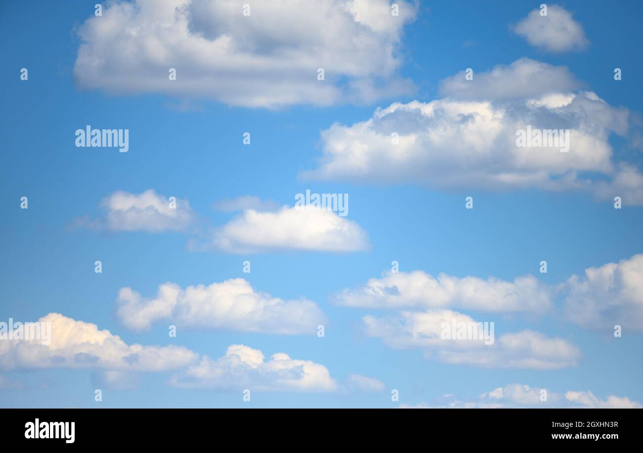 blue sky with white fluffy clouds on a summer day Stock Photo - Alamy