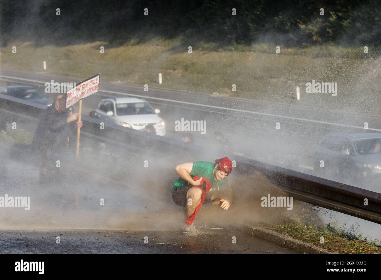 September 29, 2021, Ljubljana, Slovenia: Protesters take cover from a water cannon blast during the demonstration..Thousands of people protested against the government, covid measures, wearing masks, vaccines and RVT green pass (Recovered-Vaccinated-Tested) condition in Ljubljana, Slovenia. (Credit Image: © Luka Dakskobler/SOPA Images via ZUMA Press Wire) Stock Photo