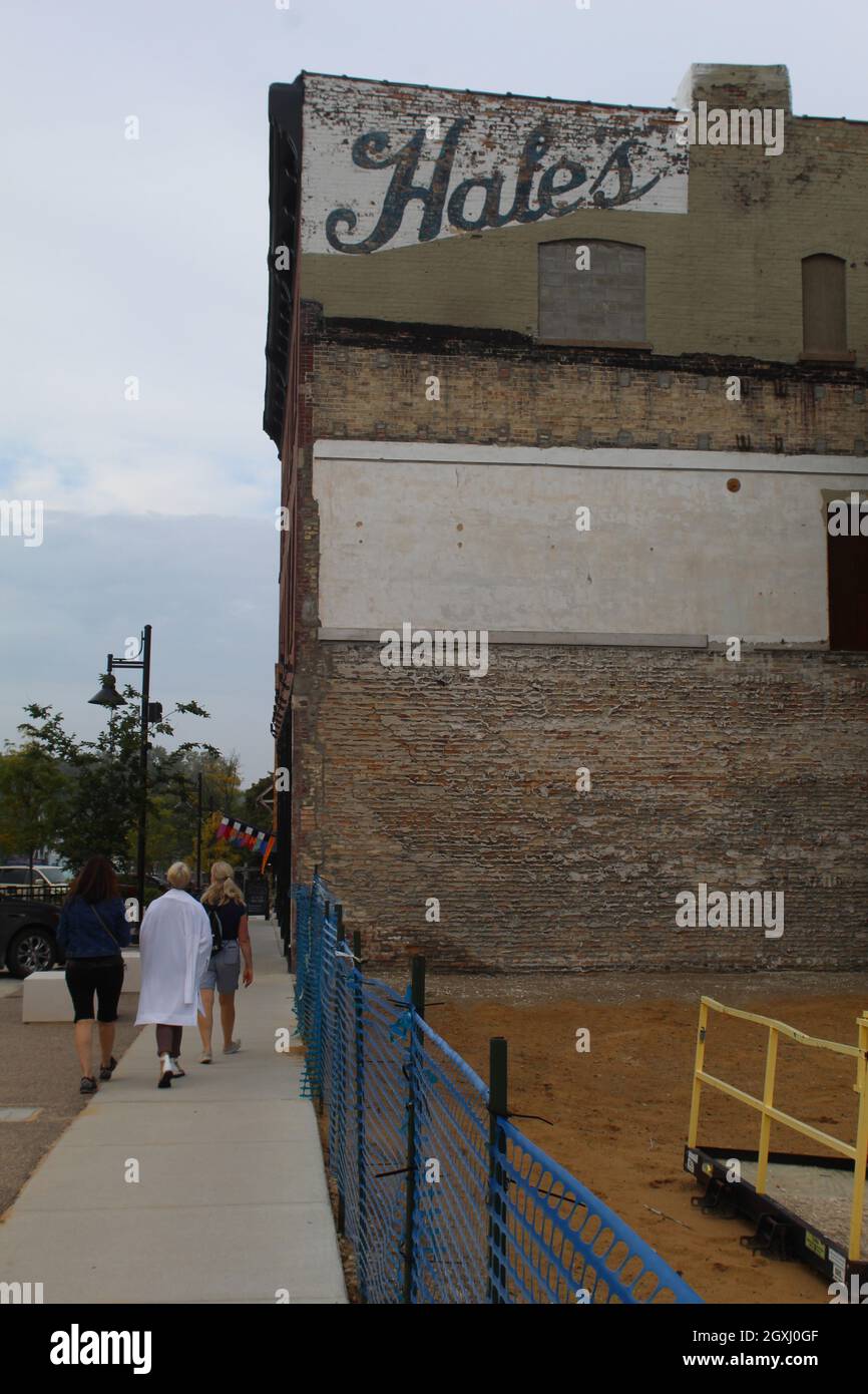 Three women walking past a Hale's Department Store ghost sign in South Haven, Michigan Stock Photo