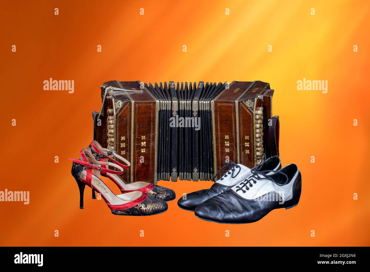 Old bandoneon with tango shoes Stock Photo