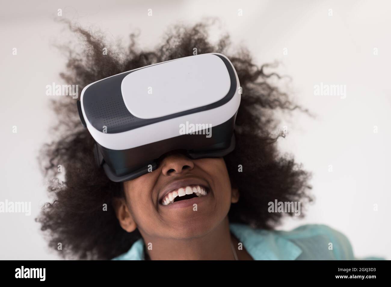 Happy african american girl getting experience using VR headset glasses ...