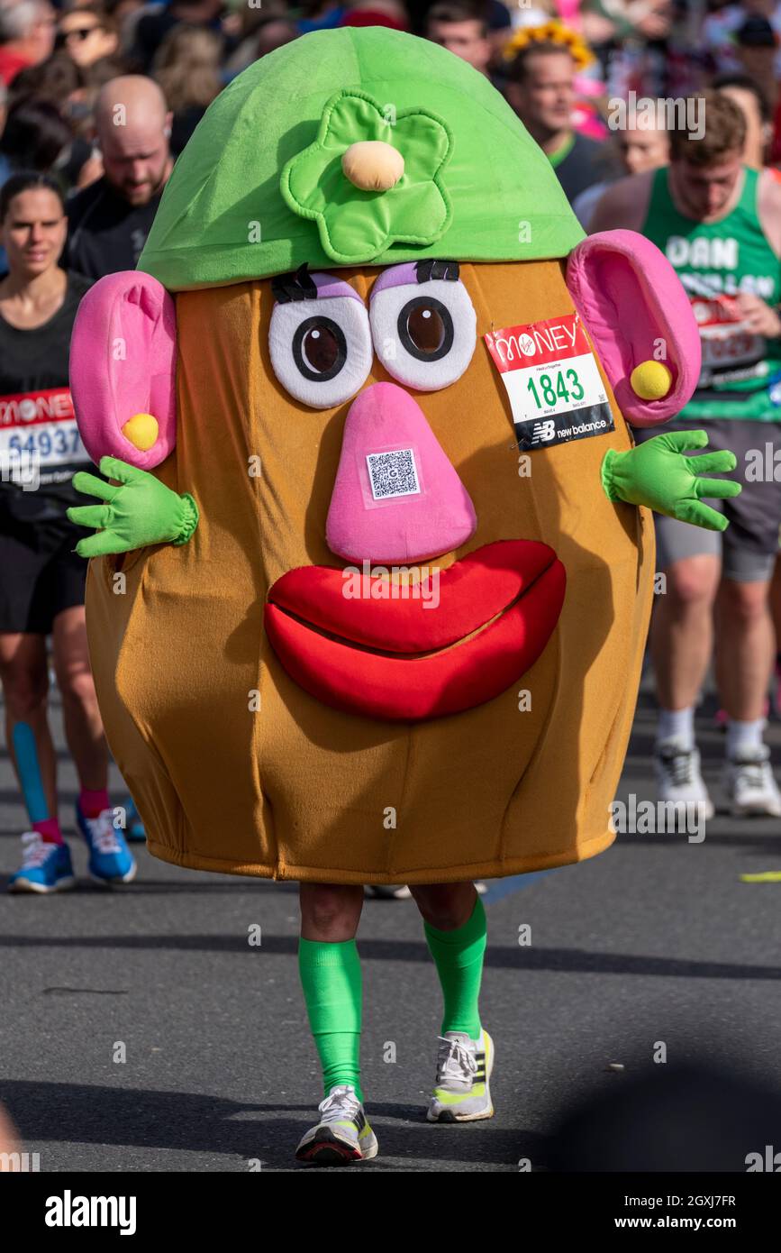 Wendy Turner racing in the Virgin Money London Marathon 2021, in Tower Hill, London, UK, wearing a Mr Potato Head costume, or Mrs Potato Head Stock Photo
