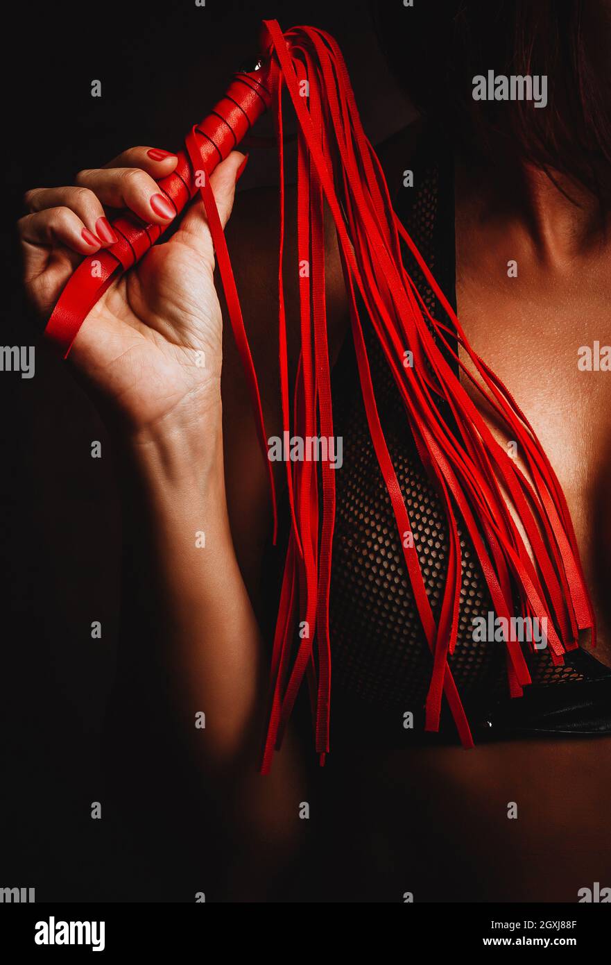 Sexy Woman with leather whip. Concept Bondage Games Stock Photo