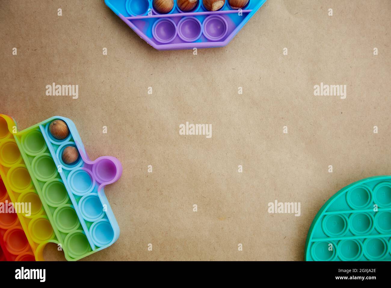 Pop it toy with hazel nuts. Invented games for motor skills development. Rainbow sensory fidget