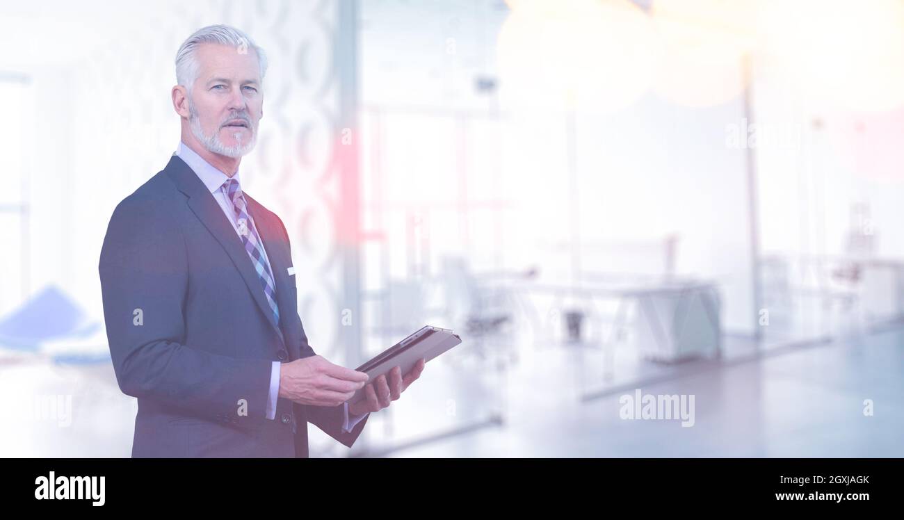 Portrait of senior businessman using tablet in front of his modern office Stock Photo