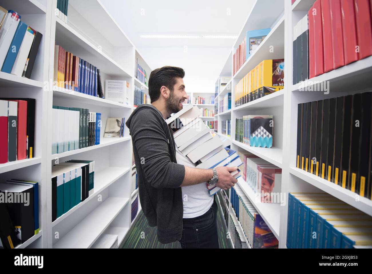 Using Books Student holding lot of books in school library. Hard worker and ...