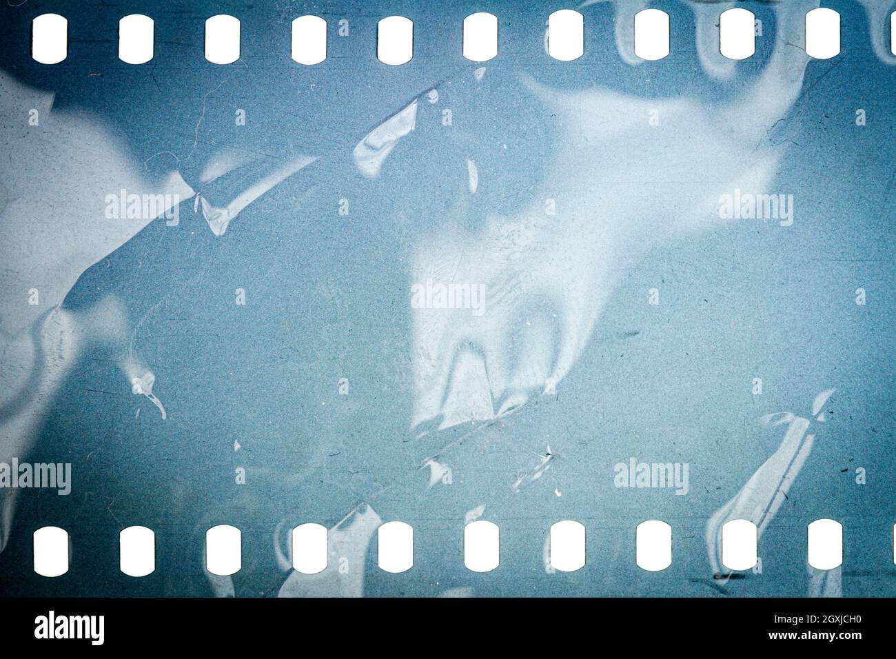 Dusty and grungy 35mm film texture or surface. Perforated camera film  isolated on white background Stock Photo - Alamy