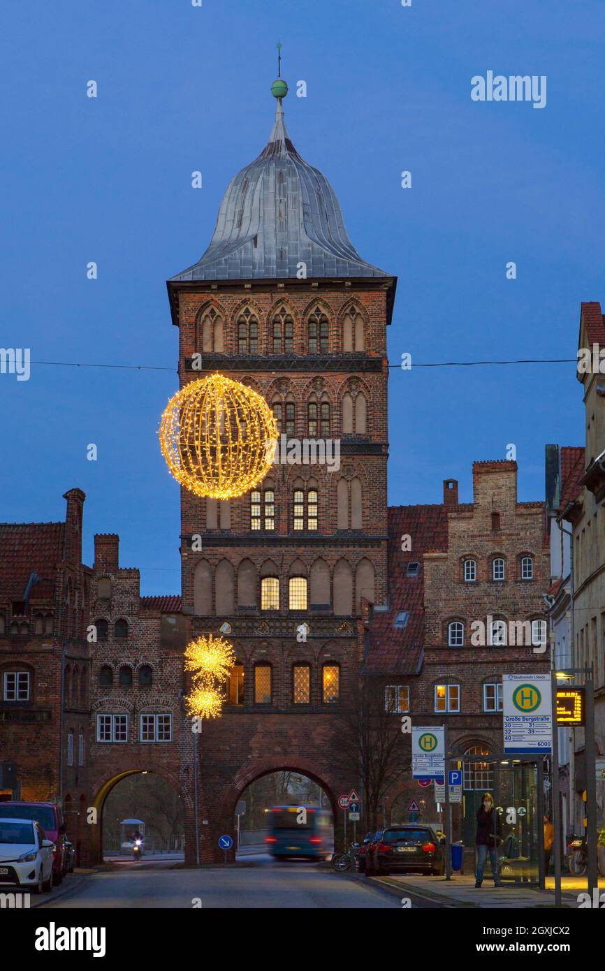 Burgtor Gate in late Gothic style, medieval northern city gate of Hanseatic Lübeck at night at Christmas time in winter, Schleswig-Holstein, Germany Stock Photo
