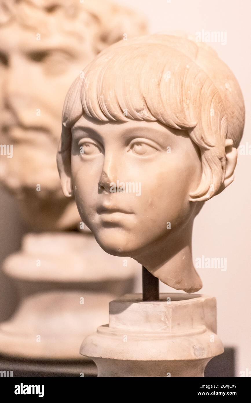 Close-up on head of ancient roman statue in ruins representing a little girl Stock Photo
