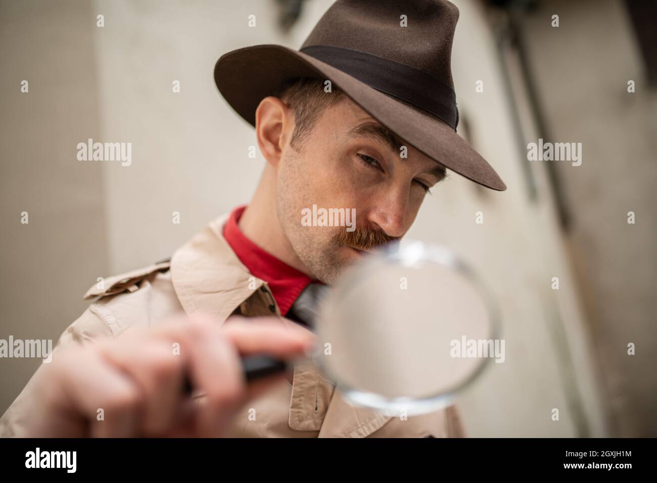 Vintage detective using a magnifying glass Stock Photo