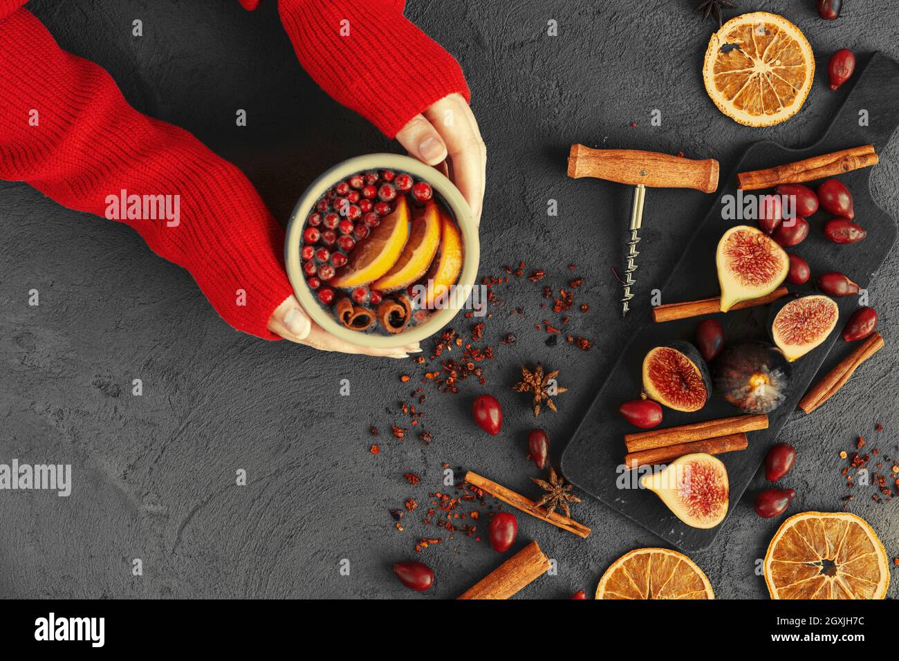 Woman's hands in warm sweater holding a cup of mulled wine Stock Photo ...