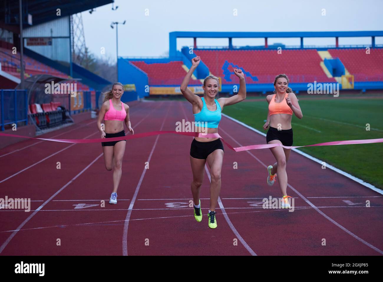 Female Runners Finishing athletic Race Together Stock Photo - Alamy